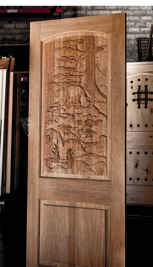 carved door with mountain lion theme