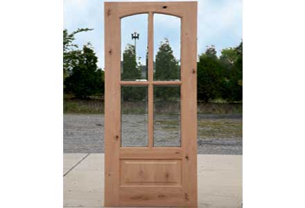 Door workshop worker sanding a door