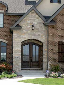 Whitehawk double doors in a covered entry at night