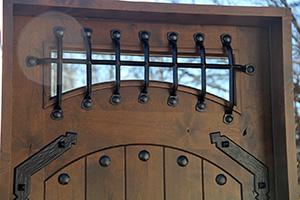 rustic medevil exterior doors with wrought iron and glass fortress doors