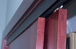 Sliding bypass door hardware with bronze facia